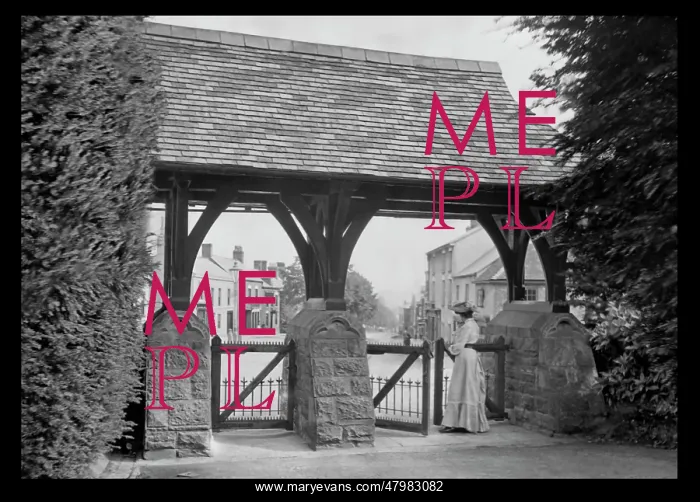 : Woman standing at a roofed gate : Woman standing at a roofed gate