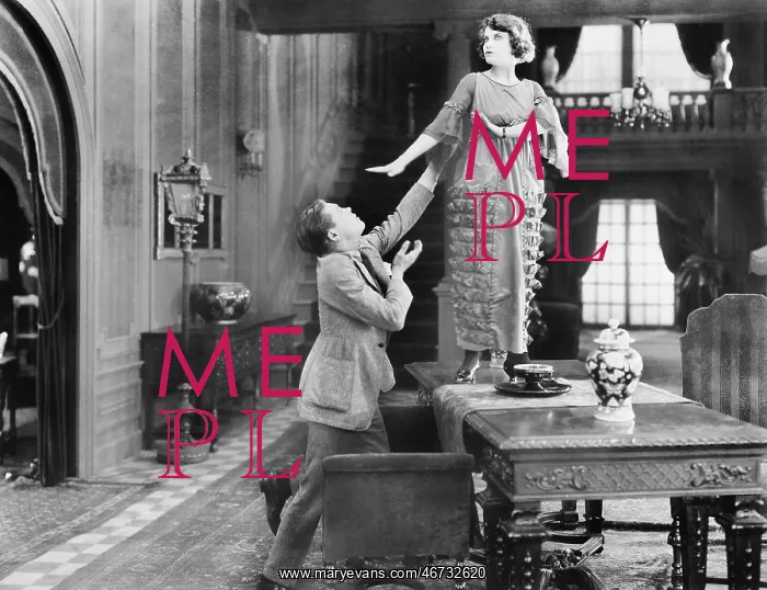  : Woman standing on a table being adored by a man