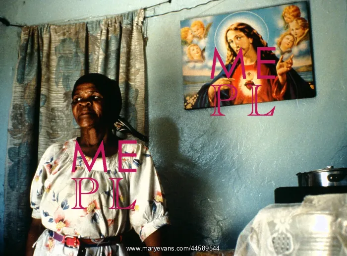 : A woman stands in her home, alongside cooking : A woman stands in her home, alongside cooking