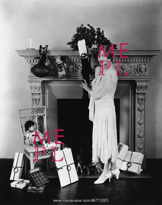 : Woman stuffing Christmas stocking : Woman stuffing Christmas stocking