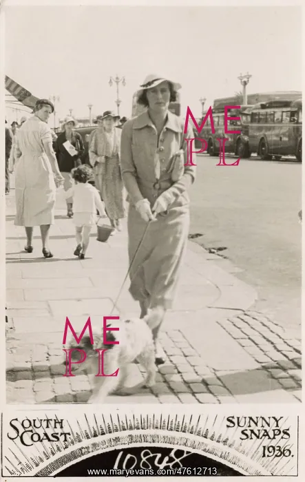 : Woman with terrier on a lead at the seaside : Woman with terrier on a lead at the seaside
