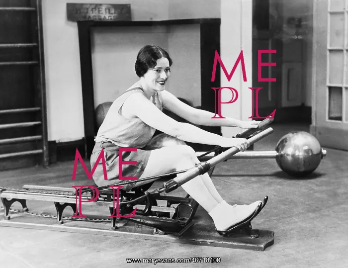 : Woman using rowing machine : Woman using rowing machine