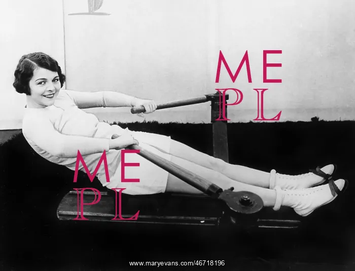 : Woman using rowing machine : Woman using rowing machine