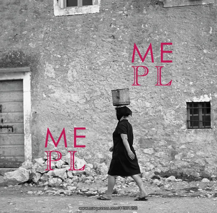 : Woman walking along a street : Woman walking along a street