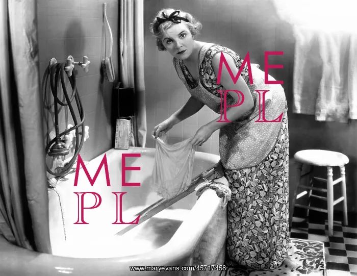  : Woman washing her laundry in the bathtub