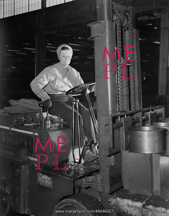 : Woman working a forklift in the production : Woman working a forklift in the production