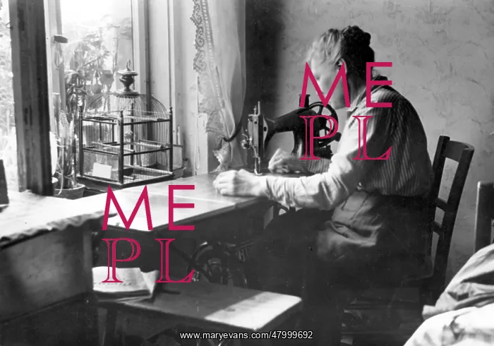 : Woman working from home at her sewing machine : Woman working from home at her sewing machine