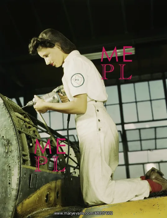 : Woman working with a rivet gun on part of : Woman working with a rivet gun on part of