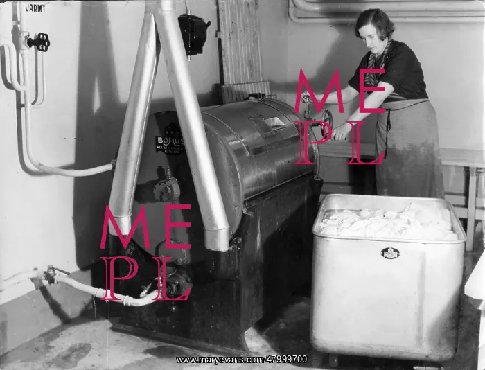 : Woman works an automatic washing machine : Woman works an automatic washing machine
