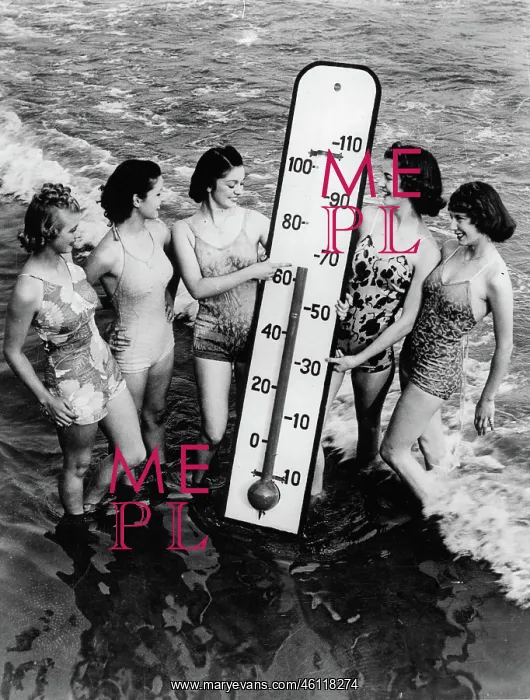 : Women on the beach with an oversized : Women on the beach with an oversized