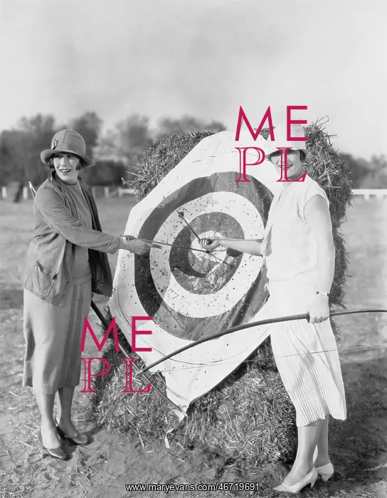 : Women with bulls eye in archery target : Women with bulls eye in archery target