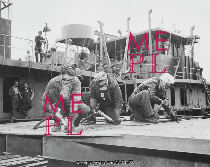 : Three women chippers working in a shipbuilding shipyard : Three women chippers working in a shipbuilding shipyard
