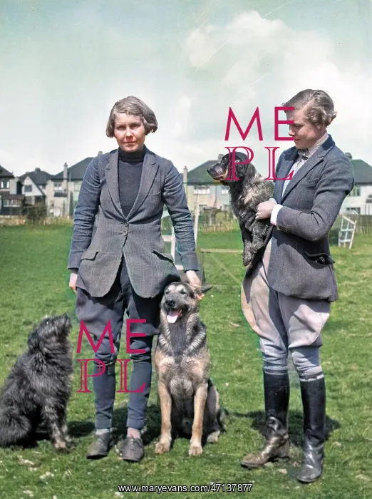  : Two women with three dogs in a field