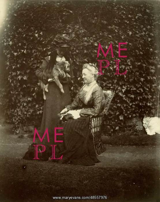  : Two women with two dogs in a garden
