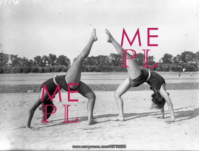 : Two women doing gymnastics : Two women doing gymnastics