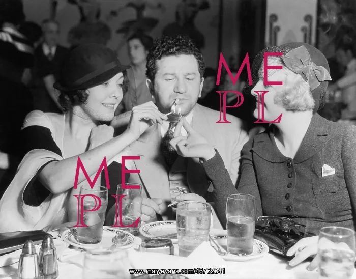 : Two women lighting a cigarette for a man : Two women lighting a cigarette for a man