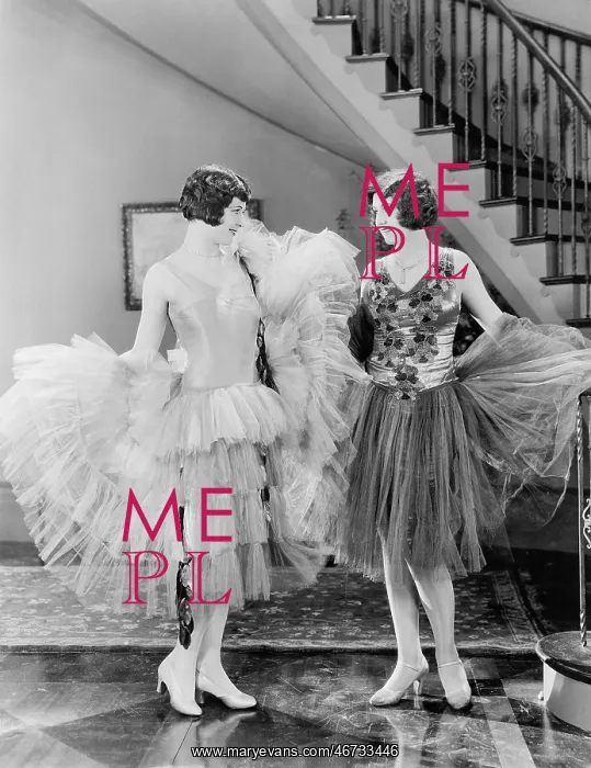 : Two women looking at each others dresses : Two women looking at each others dresses