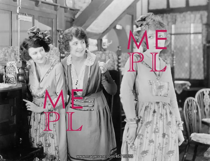 : Two women looking at a third woman : Two women looking at a third woman