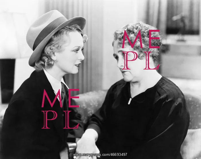 : Two women, one older, talking with each other and : Two women, one older, talking with each other and
