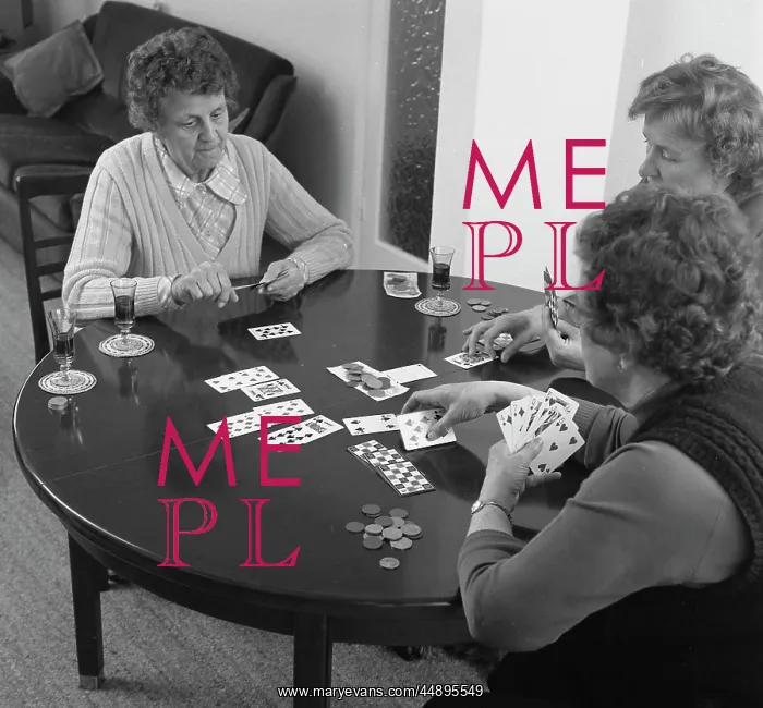 : Three women playing cards at a table : Three women playing cards at a table