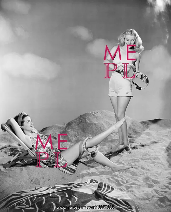 : Two women relax at the beach : Two women relax at the beach