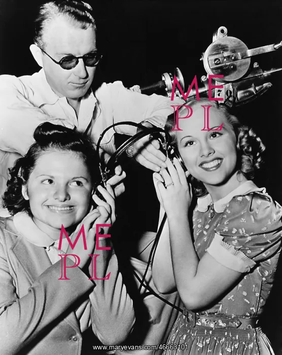  : Women sharing pair of headphones
