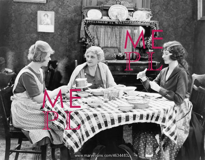 : Three women sitting at the dining table talking : Three women sitting at the dining table talking