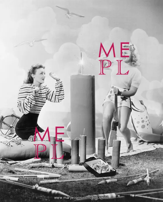 : Two women sitting around fire works : Two women sitting around fire works