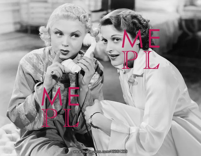 : Two women sitting together and listening on the : Two women sitting together and listening on the