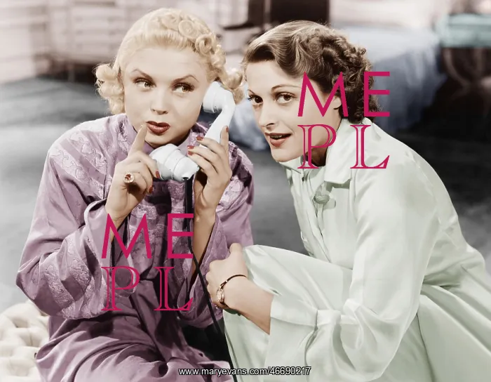 : Two women sitting together and listening on the : Two women sitting together and listening on the