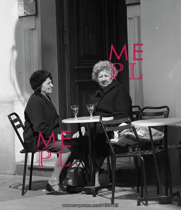: Two women sitting outside a cafe : Two women sitting outside a cafe
