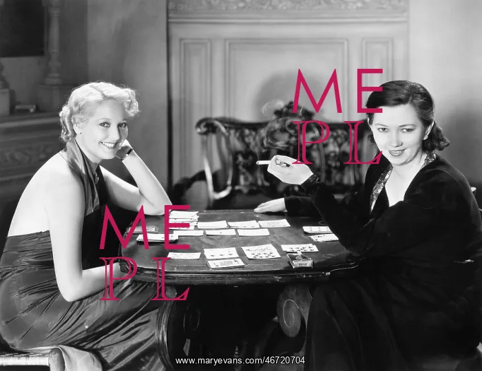  : Two women sitting together playing cards