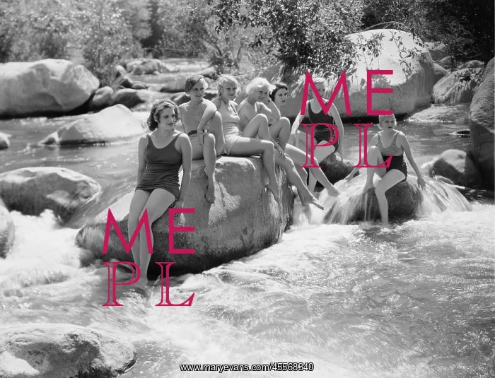 : Women sitting on rocks in bathing suits : Women sitting on rocks in bathing suits