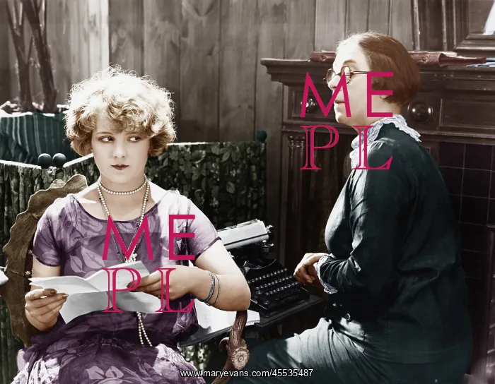 : Two women sitting together working : Two women sitting together working