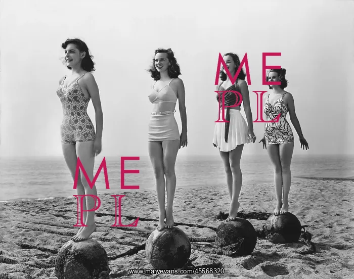  : Four women standing on balls at the beach