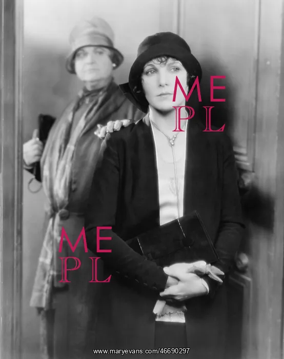 : Two women standing together at a door : Two women standing together at a door