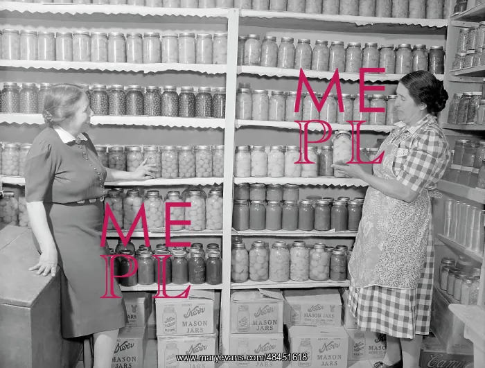 : Two women standing in a kitchen pantry. circa 1946 : Two women standing in a kitchen pantry. circa 1946