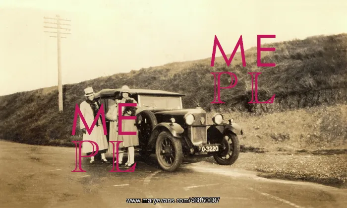 : Women standing by large car : Women standing by large car