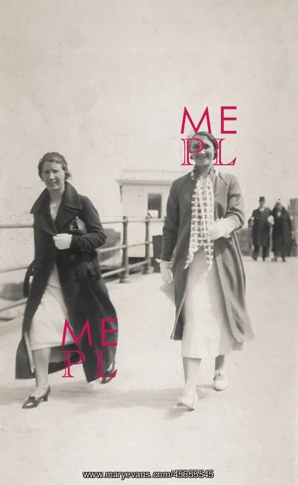: Two women stroll along the seafront : Two women stroll along the seafront