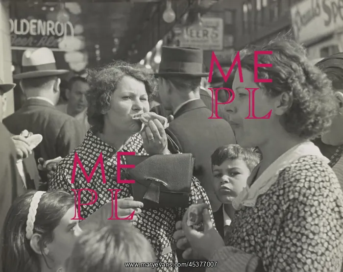 : Two women, surrounded by children, eating : Two women, surrounded by children, eating