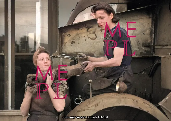 : Two women working in a garage : Two women working in a garage