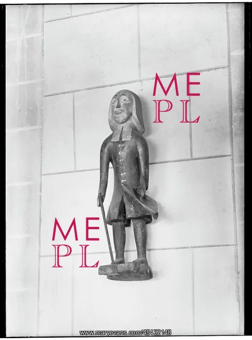 : Wooden figure on the wall above a poor box in the cathedral : Wooden figure on the wall above a poor box in the cathedral