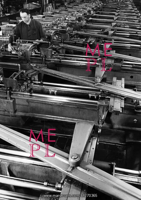 : A worker in the armaments industry operates a machine park : A worker in the armaments industry operates a machine park