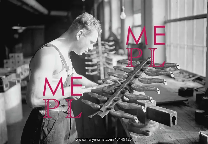 : Worker building rubber doll molds, 1936 : Worker building rubber doll molds, 1936