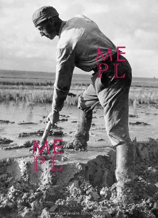 : A worker commissionaire at his work in the mud : A worker commissionaire at his work in the mud
