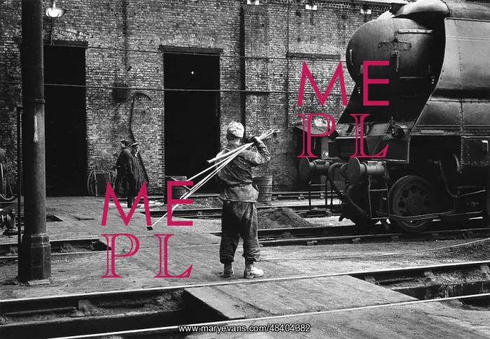 : Worker with fire-irons at Nine Elms Old Shed : Worker with fire-irons at Nine Elms Old Shed