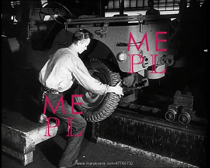  : A Worker Fitting Wheels on a Car at an American Factory