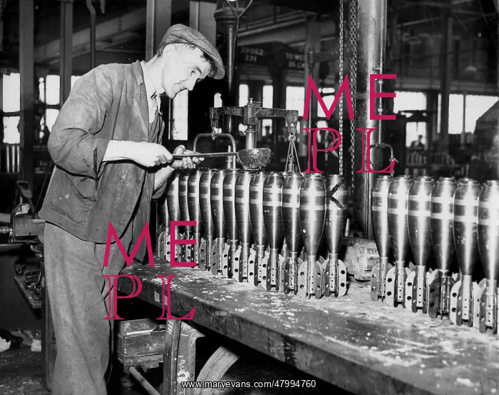 : Worker producing mortars in British munitions factory : Worker producing mortars in British munitions factory