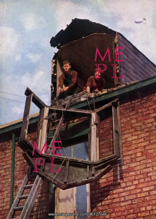 : Two workers lowering a window pane : Two workers lowering a window pane