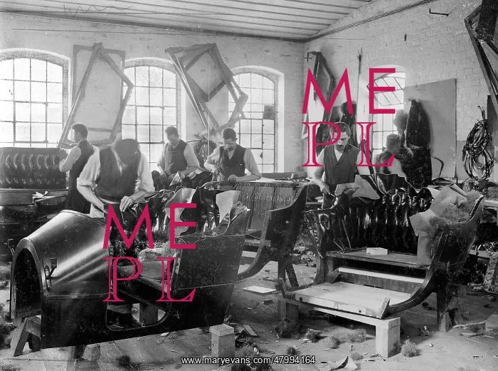 : Workers making car seats in German upholstery workshop : Workers making car seats in German upholstery workshop